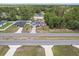 Aerial view of home, highlighting solar panels, yard, pool, and adjacent homes in a neighborhood setting at 603 Marion Oaks Blvd, Ocala, FL 34473