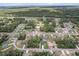 Community aerial view showcasing homes surrounded by trees and roads, highlighting the neighborhood's layout at 603 Marion Oaks Blvd, Ocala, FL 34473
