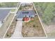 Aerial view of single-story home with private pool, patio, solar panels, and large driveway at 603 Marion Oaks Blvd, Ocala, FL 34473