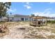 Backyard with a pergola, fire pit, and a modern house with solar panels, perfect for outdoor living at 603 Marion Oaks Blvd, Ocala, FL 34473