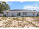 Backyard featuring solar panels and a patio area with a grill and chairs at 603 Marion Oaks Blvd, Ocala, FL 34473