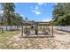Backyard featuring a wood pergola with seating, perfect for outdoor relaxation and entertaining guests at 603 Marion Oaks Blvd, Ocala, FL 34473