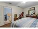 Spacious bedroom featuring wood floors, a dresser, and an open view to the bathroom at 603 Marion Oaks Blvd, Ocala, FL 34473