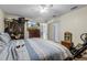 Neutral bedroom with striped bedspread and furniture next to an open doorway at 603 Marion Oaks Blvd, Ocala, FL 34473