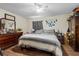 Neutral bedroom featuring a striped bedspread and wooden dresser and nightstands at 603 Marion Oaks Blvd, Ocala, FL 34473