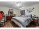 Bedroom with a striped bedspread, ceiling fan, wood flooring and furniture at 603 Marion Oaks Blvd, Ocala, FL 34473