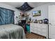A neat bedroom with a dresser, desk and TV, with plenty of decorations at 603 Marion Oaks Blvd, Ocala, FL 34473