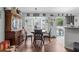 Cozy dining area featuring hardwood floors, a classic china cabinet, and a view of the backyard through a bay window at 603 Marion Oaks Blvd, Ocala, FL 34473