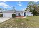 Well-maintained single-Gathering home with a blue front door, manicured front yard, and a two-car garage at 603 Marion Oaks Blvd, Ocala, FL 34473