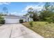 Charming single-story home with a well-maintained lawn, a two-car garage, and a paved driveway at 603 Marion Oaks Blvd, Ocala, FL 34473