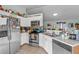 Well-lit kitchen with white cabinets, stainless steel appliances, and tiled floors, creating a clean and modern space at 603 Marion Oaks Blvd, Ocala, FL 34473
