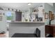 Kitchen bar with white beadboard, seating, and easy access to the sliding door to the backyard at 603 Marion Oaks Blvd, Ocala, FL 34473