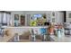View of kitchen sink, counter with a bowl of green apples and TV in the background at 603 Marion Oaks Blvd, Ocala, FL 34473