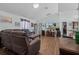 Inviting living room with hardwood floors, a large TV, and lots of natural light at 603 Marion Oaks Blvd, Ocala, FL 34473