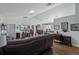 Open-concept living room boasts hardwood floors, a TV, and flows into the dining area and kitchen at 603 Marion Oaks Blvd, Ocala, FL 34473