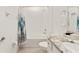 Bright bathroom featuring a tub with tiled walls and a granite countertop vanity at 6175 Sw 88Th Loop, Ocala, FL 34476