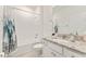 Bathroom featuring a tub with tiled walls and a granite countertop vanity at 6175 Sw 88Th Loop, Ocala, FL 34476