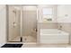 Bathroom featuring a walk-in shower and bathtub, creating a functional and relaxing space at 6175 Sw 88Th Loop, Ocala, FL 34476