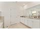 Bright bathroom with double granite vanity, white cabinets, and a tiled floor at 6175 Sw 88Th Loop, Ocala, FL 34476