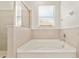 Bathroom featuring a pristine bathtub, offering a relaxing and comfortable bathing experience at 6175 Sw 88Th Loop, Ocala, FL 34476