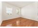 Empty room featuring natural light and hardwood floors, ready to be personalized as a bedroom or office at 6175 Sw 88Th Loop, Ocala, FL 34476