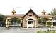 Charming community entrance showcasing stonework and archways, creating a welcoming first impression at 6175 Sw 88Th Loop, Ocala, FL 34476