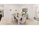 Dining area with a mirrored table, plush chairs, and decorative accents at 6175 Sw 88Th Loop, Ocala, FL 34476