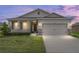 Charming single-story home with a two-car garage, well-maintained lawn, and stone accents at 6175 Sw 88Th Loop, Ocala, FL 34476