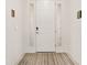 Bright foyer featuring a white door with sidelights and a neutral-toned striped rug at 6175 Sw 88Th Loop, Ocala, FL 34476