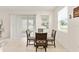 Bright kitchen features a glass table with seating and access to the yard with sliding glass doors at 6175 Sw 88Th Loop, Ocala, FL 34476