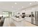 Well-lit kitchen featuring stainless steel appliances, granite countertops, and an open layout with seamless backyard access at 6175 Sw 88Th Loop, Ocala, FL 34476