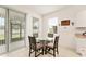 Bright kitchen features a glass table with seating and access to a screened patio with sliding glass doors at 6175 Sw 88Th Loop, Ocala, FL 34476
