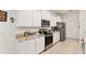 Well-equipped kitchen featuring stainless steel appliances, white cabinets, and granite countertops for modern living at 6175 Sw 88Th Loop, Ocala, FL 34476