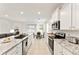 Well-appointed kitchen featuring stainless steel appliances and granite countertops with open access to living and dining areas at 6175 Sw 88Th Loop, Ocala, FL 34476