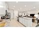 Modern kitchen features an expansive island with granite countertops, stainless appliances, and open layout at 6175 Sw 88Th Loop, Ocala, FL 34476