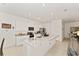 Bright kitchen showcases a granite island, stainless steel appliances, and ample cabinetry for storage and functionality at 6175 Sw 88Th Loop, Ocala, FL 34476