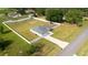 Aerial view of fenced-in property with green lawn, and a single-story home with attached garage at 6250 Se 88Th St, Ocala, FL 34472