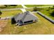 A wide aerial view reveals a screened in porch and lush lawn in the home's fenced backyard at 6250 Se 88Th St, Ocala, FL 34472