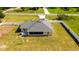 A wide aerial view reveals a screened in porch and lush lawn in the home's fenced backyard at 6250 Se 88Th St, Ocala, FL 34472