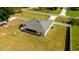 An aerial shot shows a well-maintained lawn in the backyard, and a screened in porch at 6250 Se 88Th St, Ocala, FL 34472