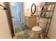 Bathroom featuring granite vanity, a framed mirror, neutral tiled floors with shelf storage at 6250 Se 88Th St, Ocala, FL 34472