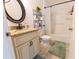 Bathroom with granite vanity, framed mirror, tiled floors and shower with storage at 6250 Se 88Th St, Ocala, FL 34472