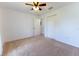 Inviting bedroom features a ceiling fan, neutral carpet, and an entrance to another room at 6250 Se 88Th St, Ocala, FL 34472