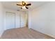 Cozy bedroom with neutral carpet features a ceiling fan and closet, offering a comfortable space at 6250 Se 88Th St, Ocala, FL 34472
