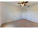 Neutral carpeted bedroom features ceiling fan and closet offering a comfortable space at 6250 Se 88Th St, Ocala, FL 34472