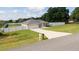 Lovely single story home with a well-manicured lawn, long driveway, white fence and an attached two-car garage at 6250 Se 88Th St, Ocala, FL 34472