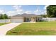 Charming single-story home featuring a well-manicured lawn, attached garage, and lovely curb appeal at 6250 Se 88Th St, Ocala, FL 34472