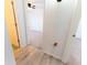 Hallway leading to a bedroom with light-colored vinyl plank flooring at 6250 Se 88Th St, Ocala, FL 34472