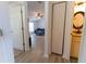 Hallway view to the living room and bathroom, showcasing the home's layout and access at 6250 Se 88Th St, Ocala, FL 34472