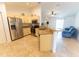 Bright kitchen with stainless steel appliances and granite countertops flowing into the living room at 6250 Se 88Th St, Ocala, FL 34472